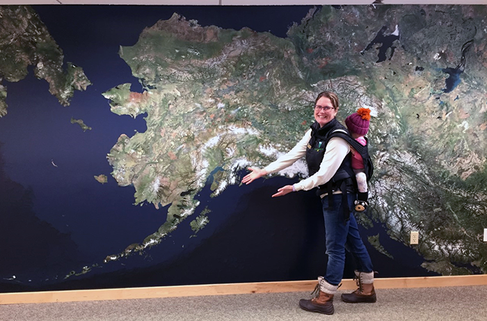 Mother and child in front of Alaska Wall Map exhibit