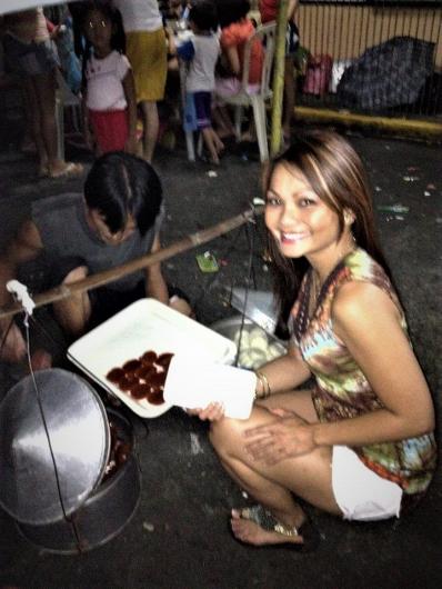 BLM Idaho State Director Executive Assistant Jennifer Pable kneeling in front of Kutsinta (steamed rice cake) during the celebration of life for her lola (grandmother) in Manila.  Photo: courtesy of Jennifer Pable.