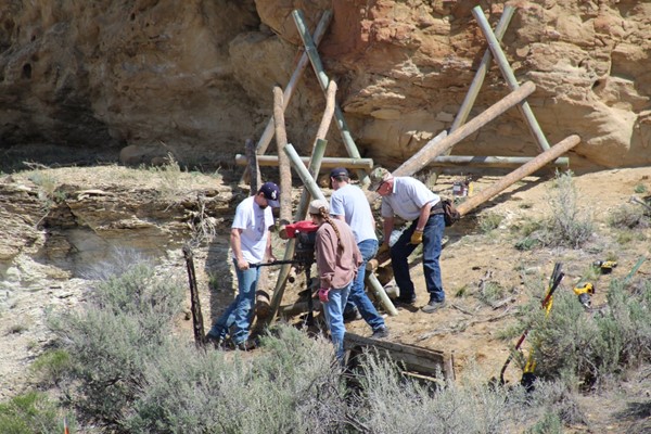 Members from the Piceance Mustangs construct a buck and pole fence. The group has built 0.25 miles of new fencing and repaired more than 1.5 miles of boundary fencing. (Photo courtesy of Piceance Mustangs)