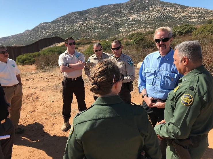 William Perry Pendley stands with BLM Law Enforcement and Border Patrol in the desert.