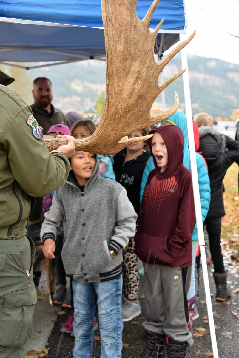 Kids stand in awe of a massive moose antler as Idaho Dept. of Fish and Game teach them about wildlife and fish found along the South Fork