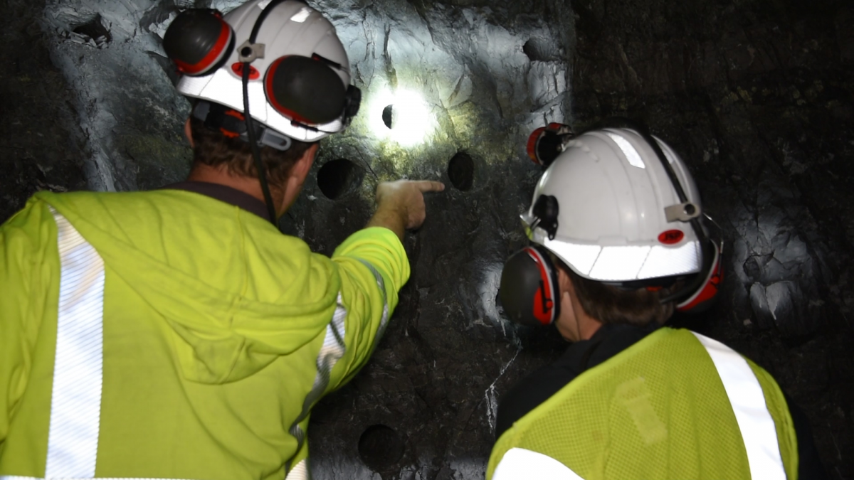 Two employees inspect an underground mine site. BLM photo.