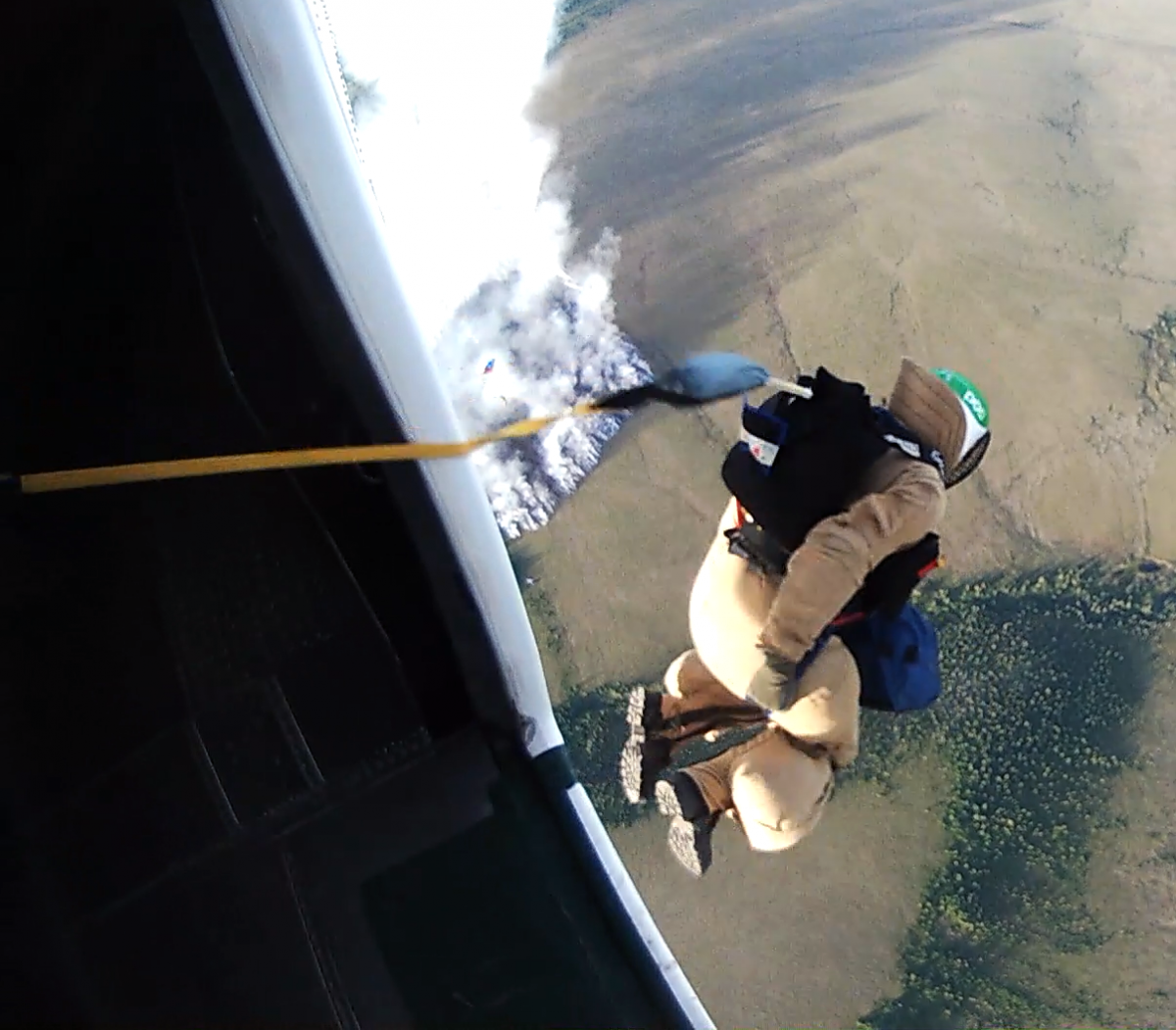 Smokejumper jumping out of plane