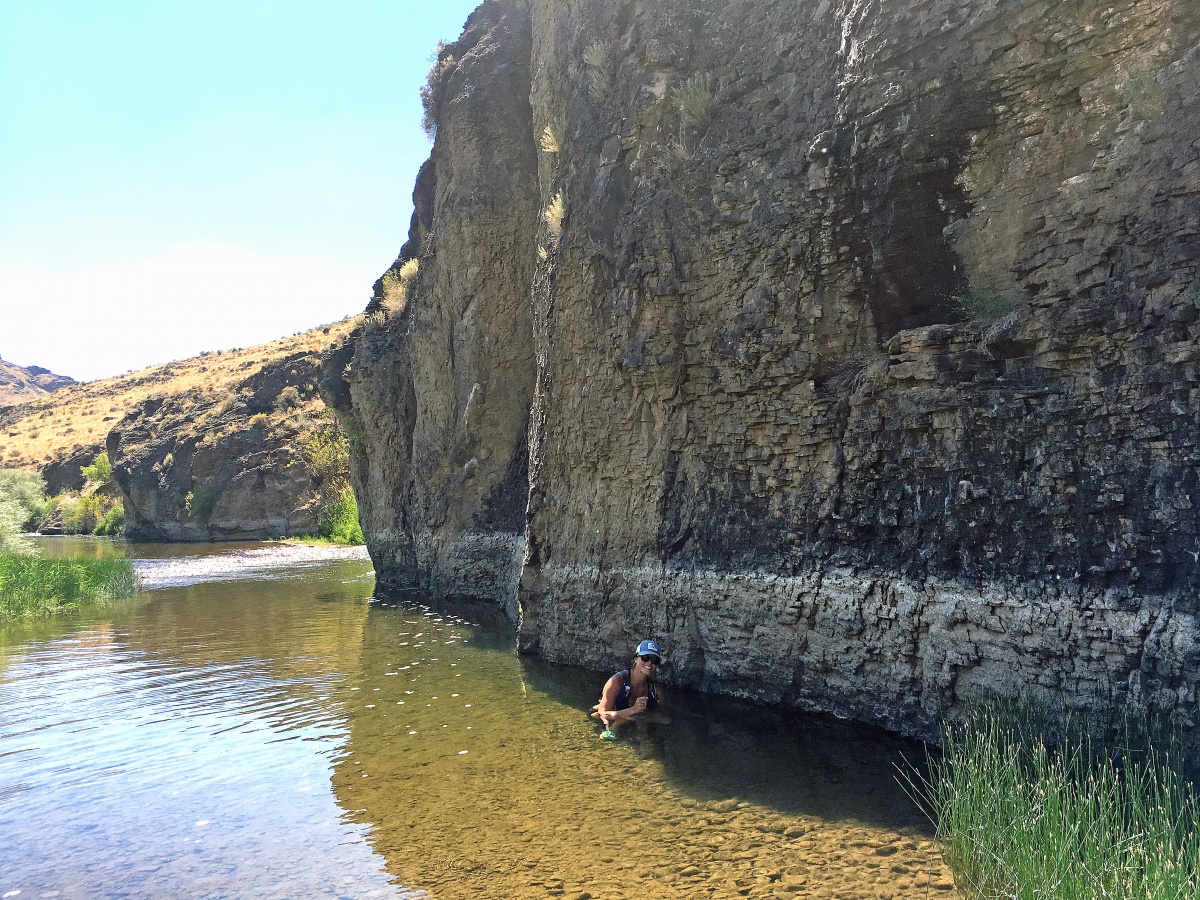 BLM Idaho Intern Angeline Getty reaching for the thermograph to collect a reading of the Bruneau River.