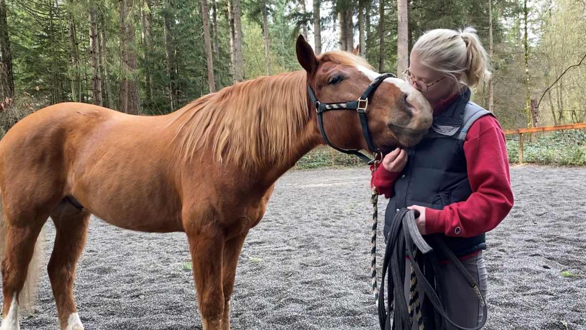 Girl riding kissing her horse. 