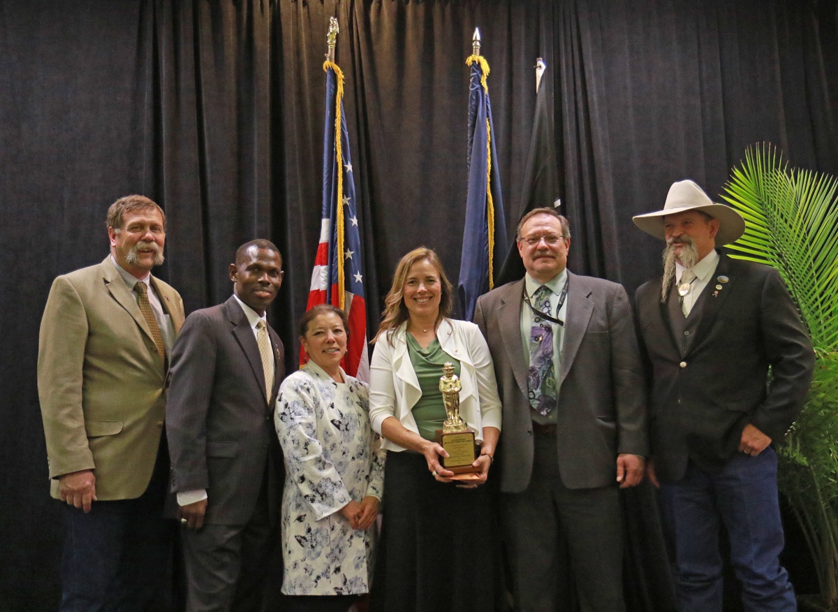 041218 Awards Ceremony - Gold Smokey Award Honoree left to right: Howard Hedrick, Acting BLM Assistant Director Fire and Aviation; Mike Nedd, Acting BLM Deputy Director of Operations; Patti Hirami, Acting Deputy Chief, U.S. Forest Service; Carrie Bilbao Gold Smokey Award Winner; Peter Ditton, Acting BLM Idaho State Director; and John Ruhs, BLM Nevada State Director