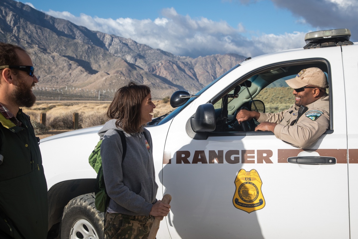 A ranger helps hikers