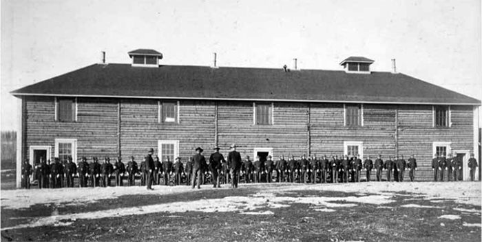 Company L, 7th Infantry, musters in front of its barracks at Fort Egbert in March 1900. 