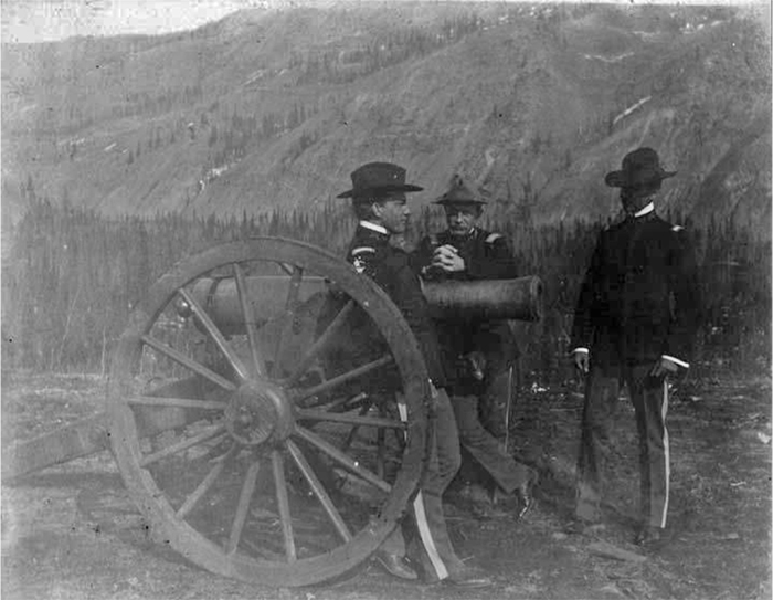 Fort Egbert soldiers stand next to a cannon on a gun carriage. Photo courtesy of University of Alaska Fairbanks archives.