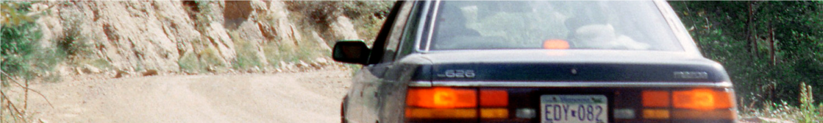 blue sedan driving on BLM dirt road