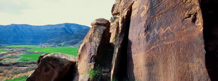 rock art on cliff with byway in background