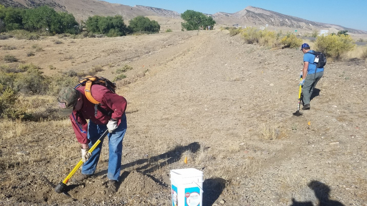 volunteers rake trail