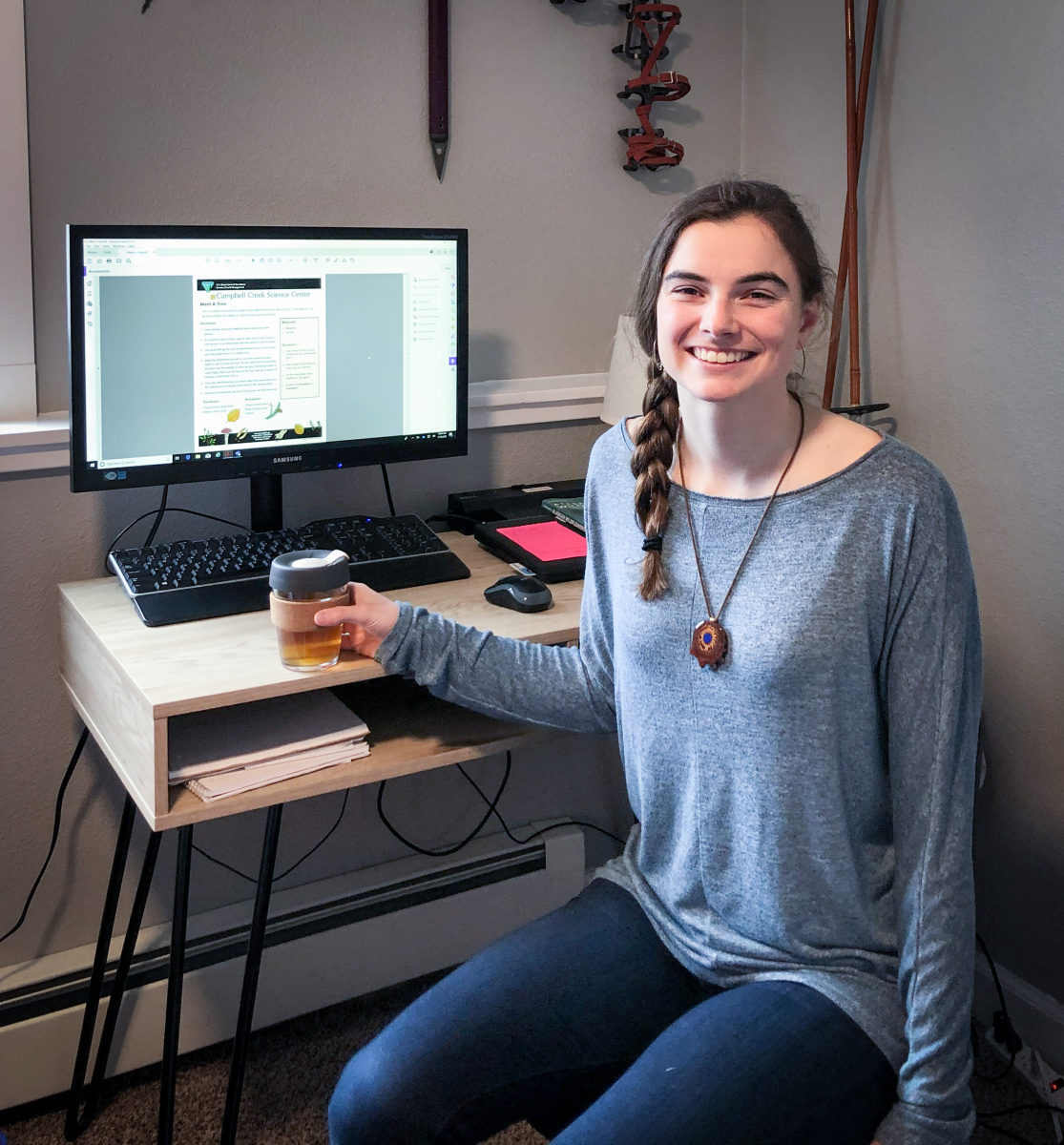 Woman sitting in front of desk with tea