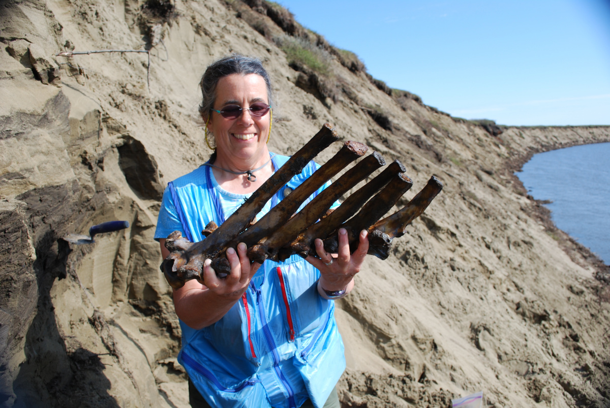 Woman holding bison vertibrae