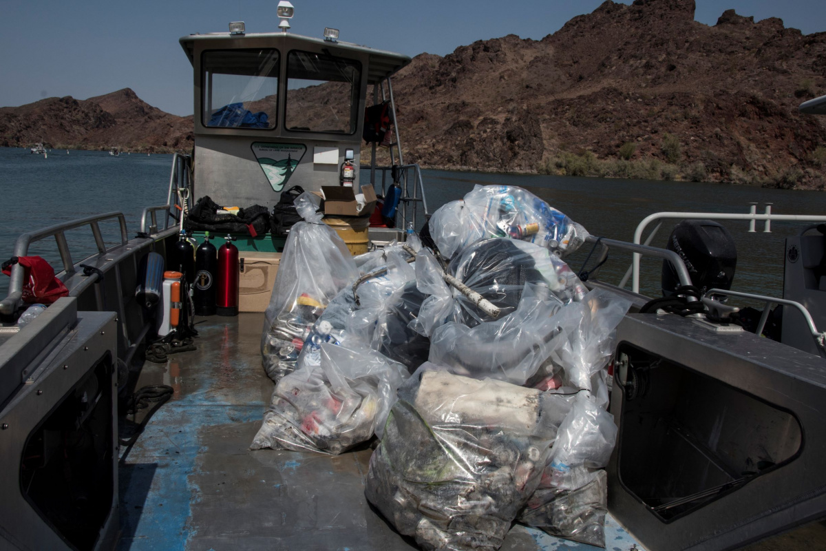 a pile of trash bags on the deck of a boat