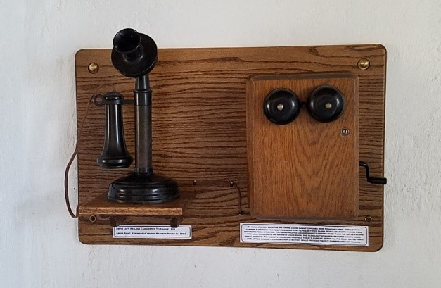 a candlestick-style telephone on a wall