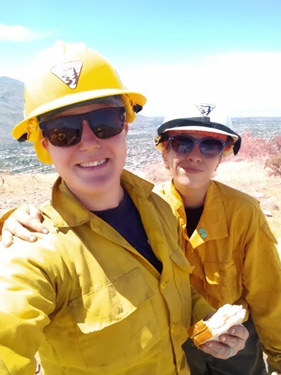 Two fire fighters posing for a photo during a lunch brake