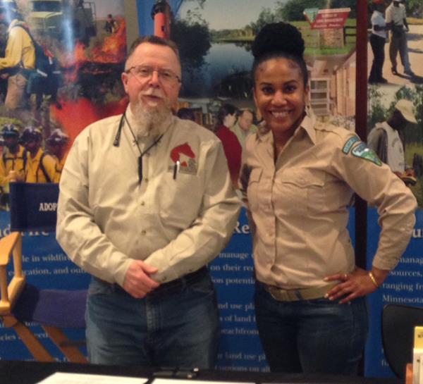 A man and a woman standing in front of a large display about the BLM.