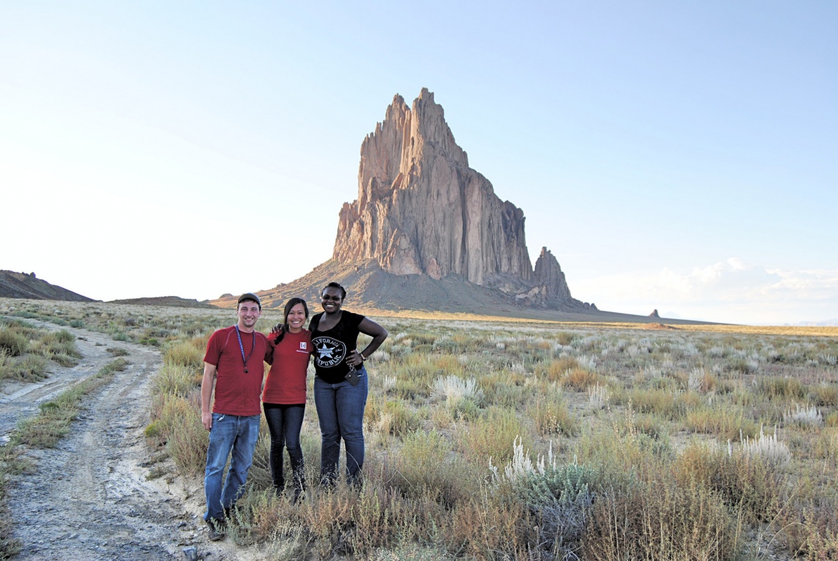Three BLM interns enjoy a landscape view of rugged mountains. BLM photo.