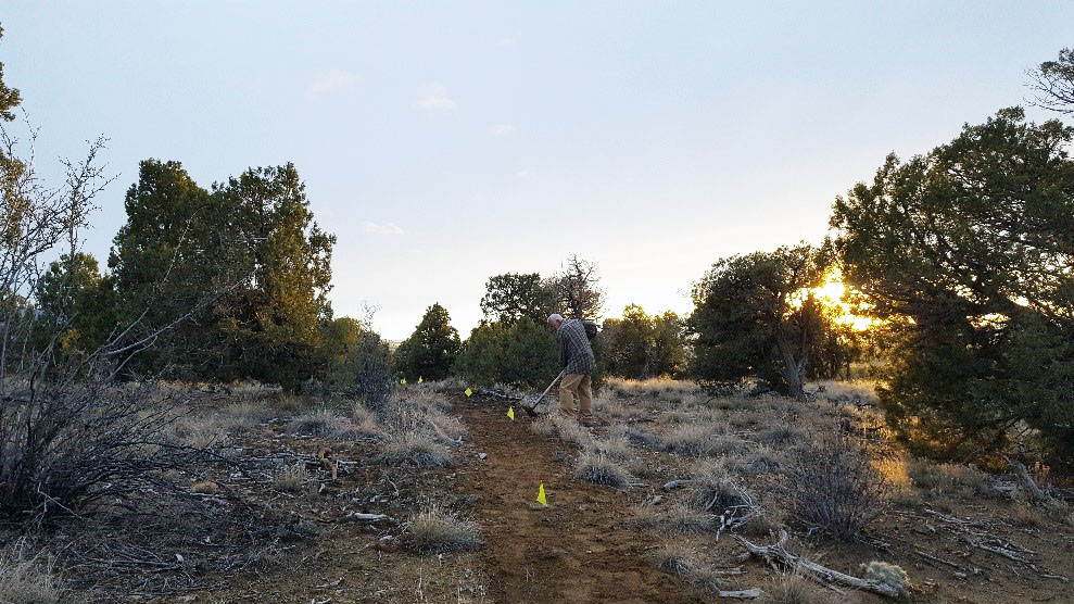 volunteer works on trail at Phil's World