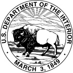 A bison stands in a valley with the sun peaking over a mountain range in the background.  U.S. Department of the Interior logo, March 3, 1849