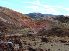 Giant red rock hills in front of green hillsides. Photo courtesy of California State Parks.