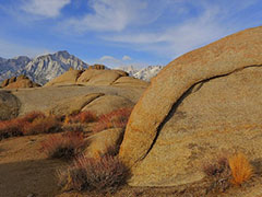 Rocks, vegetation and snow capped mountains.  Photo by David Kirk, BLM.