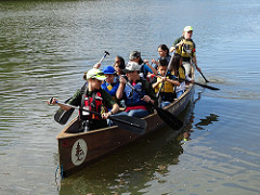 A group of children paddle a canoe with two adult leaders.  Photo by Samantha Storms, BLM.