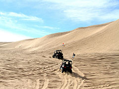 Dune Buggies make track in tall sand dunes.  Photo by Michelle Puckett, BLM.