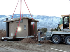 New vault toilet lowered into place at the BLM Rice Canyon Off Highway Vehicle Area. Photo by Marisa Willliams, BLM.