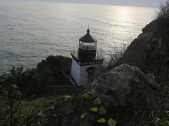 A light house sits on a rocky cliff overlooking the Pacific Ocean.  Photo by BLM.