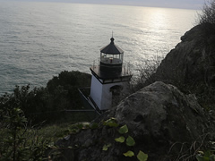 A light house sits on a rocky cliff overlooking the Pacific Ocean.  Photo by BLM.