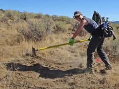 A woman clears a trail using a hand tool.  Photo by Stan Bales, BLM.