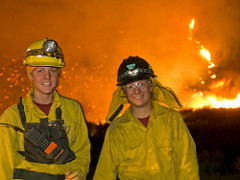 Two female firefighters near a wildfire.  Photo by BLM.