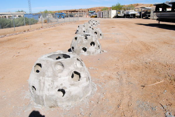 honeycomb-shaped concrete structures sit on a dirt surface