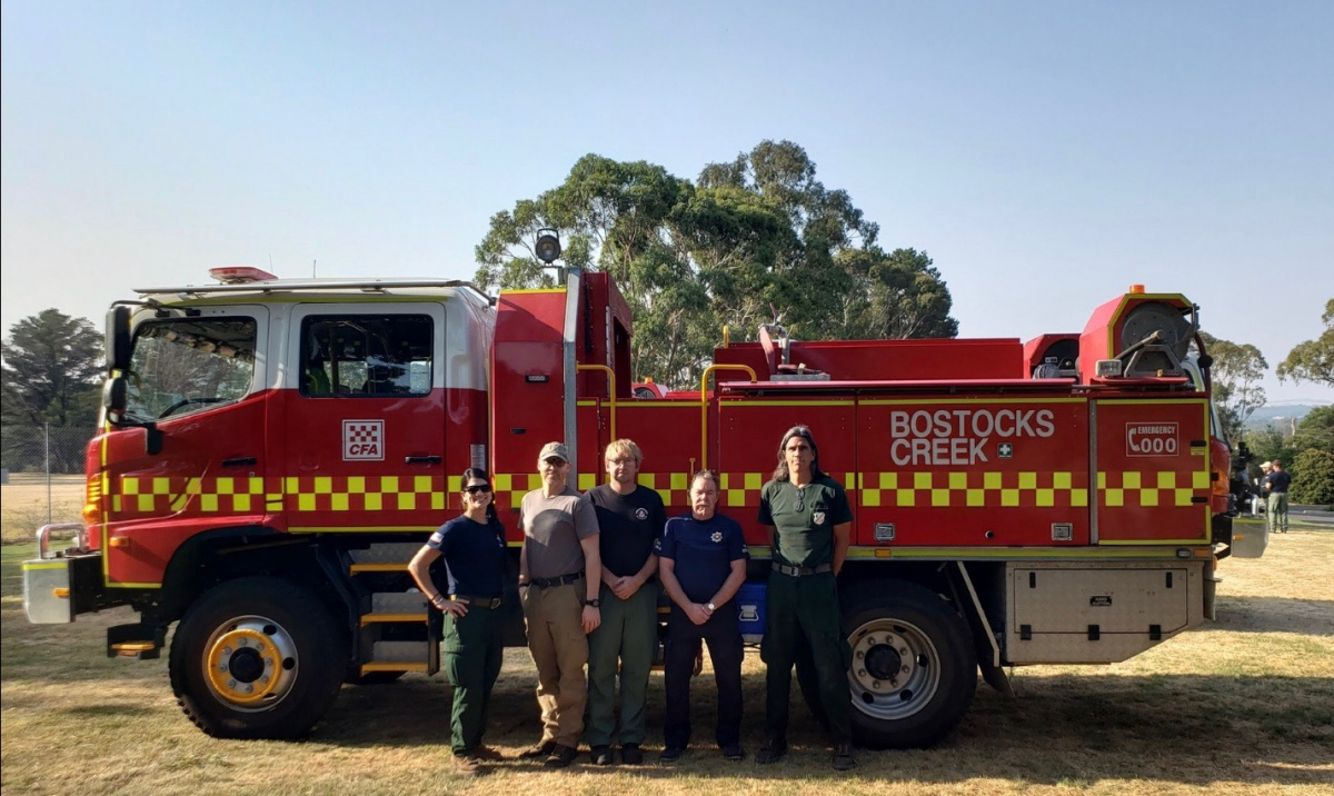 Australian fire engine with 5 firefighters standing next to it