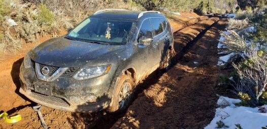 Vehicle stuck in muddy dirt road