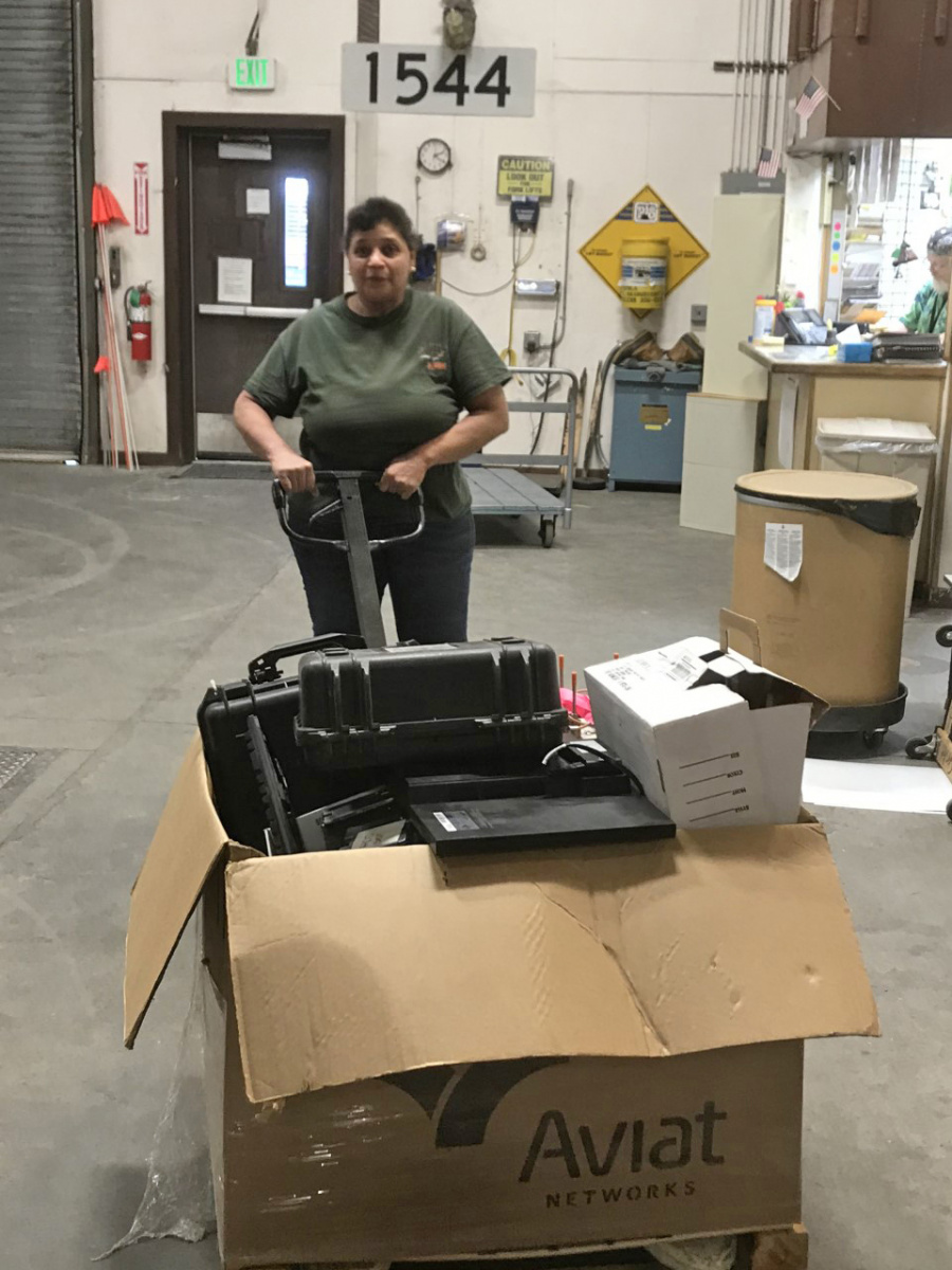 Warehouse worker pushing a pallet of equipment