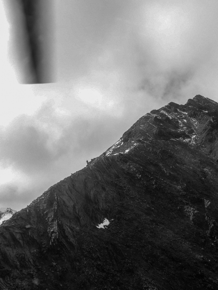 Man walking along mountain ridge