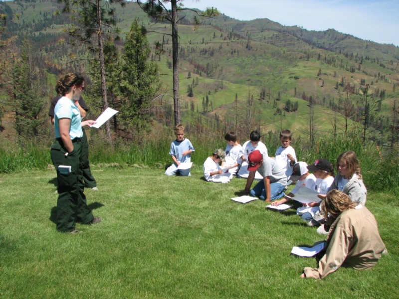 Firefighter talks with children about preventing wildfires.