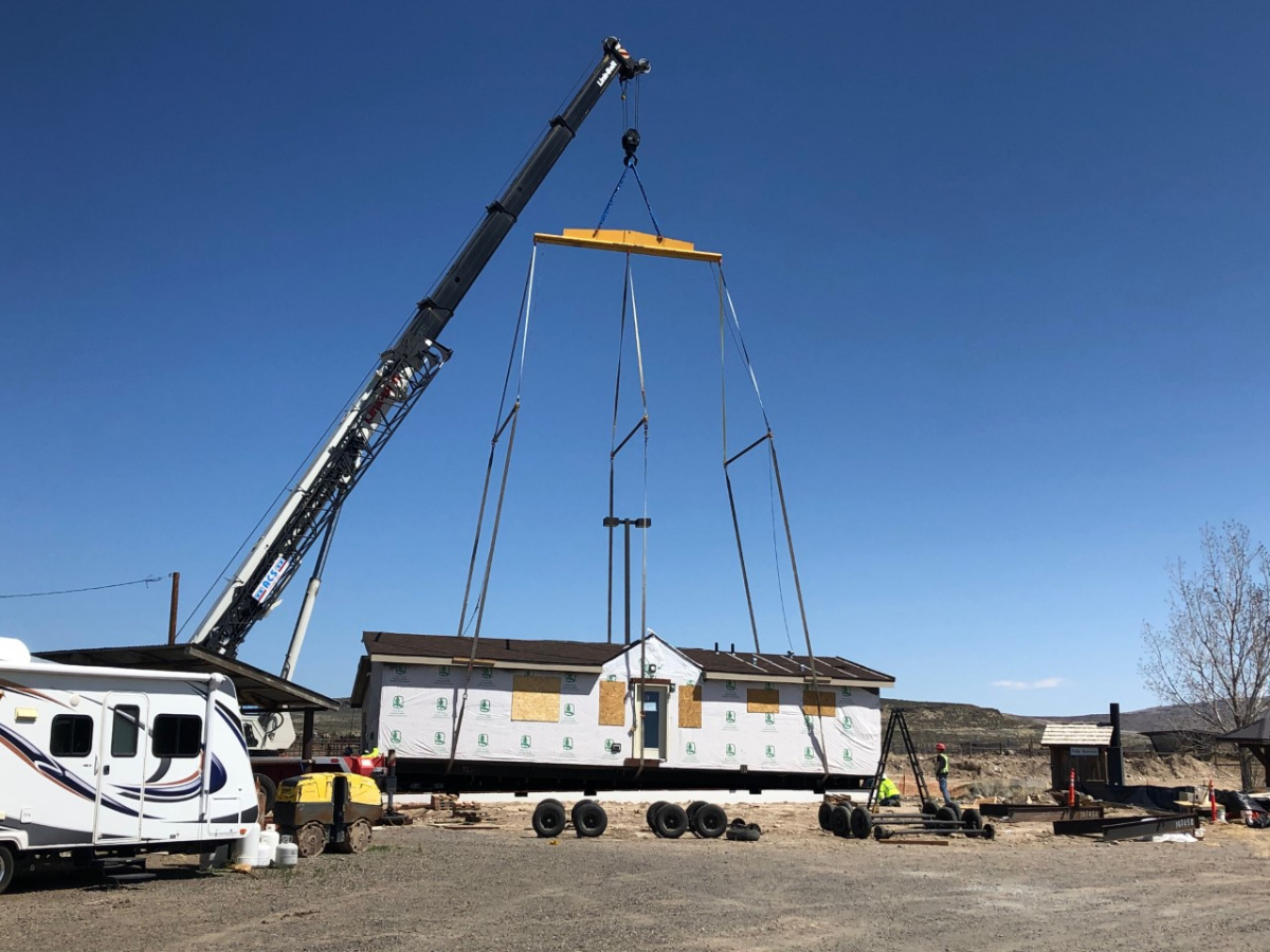 Image of modular building being lowered by a crane. Photo by the BLM.