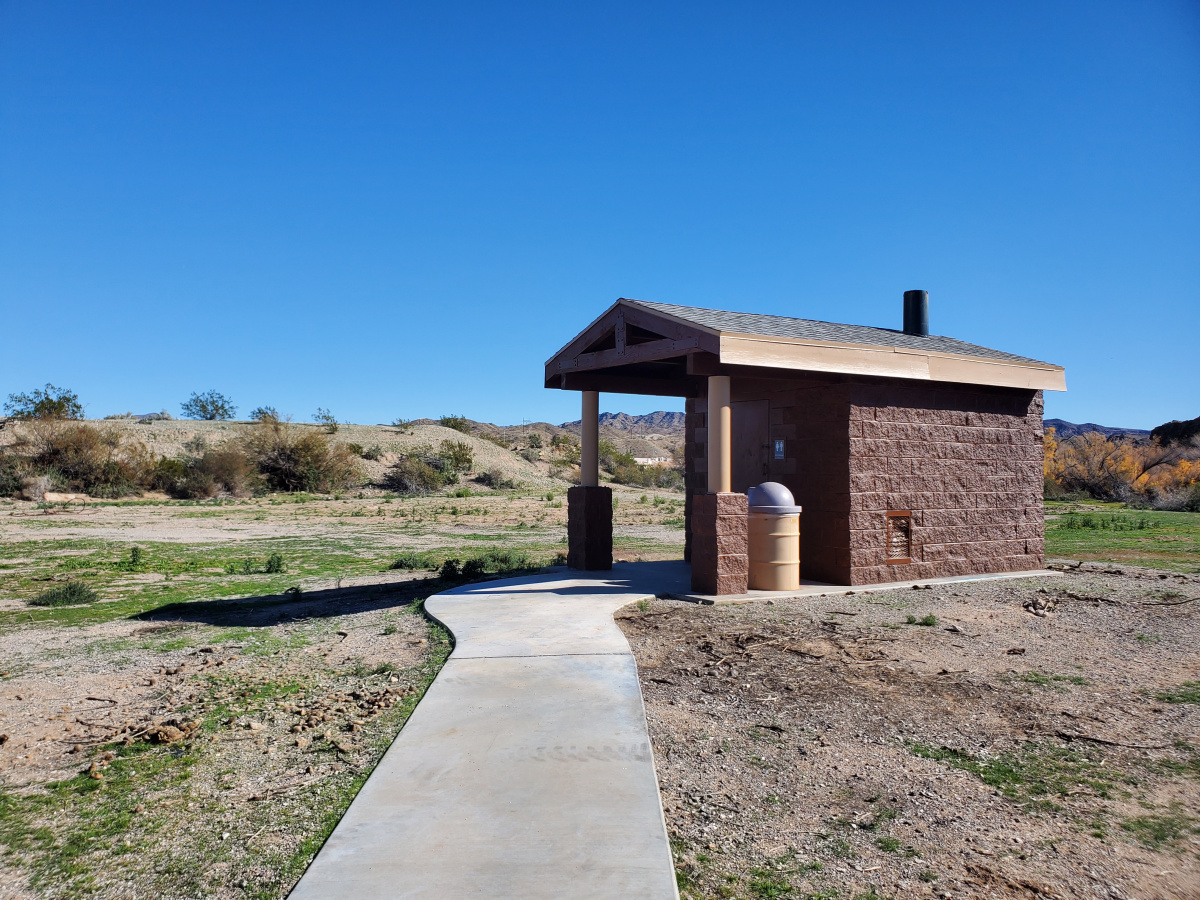 a brick structure with a black chimney