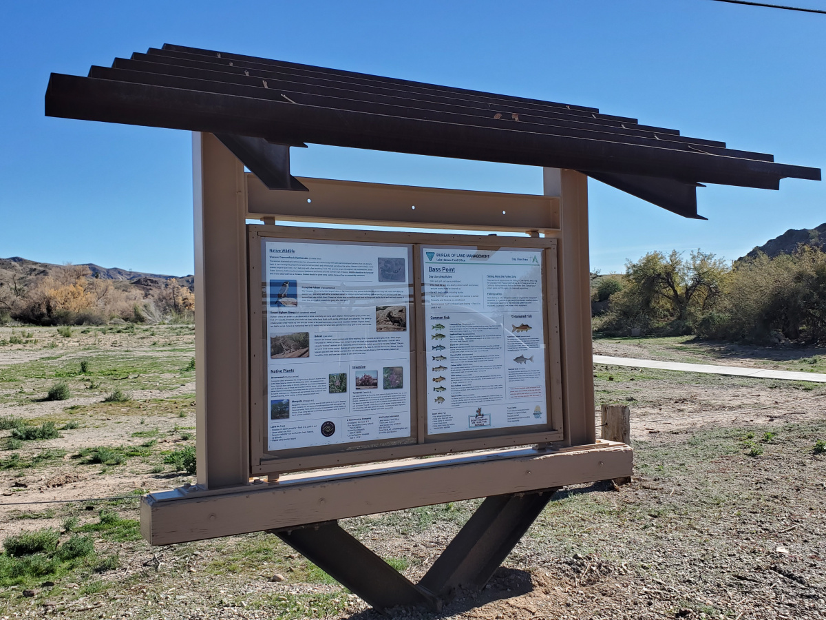 a metal kiosk with two bulletin boards