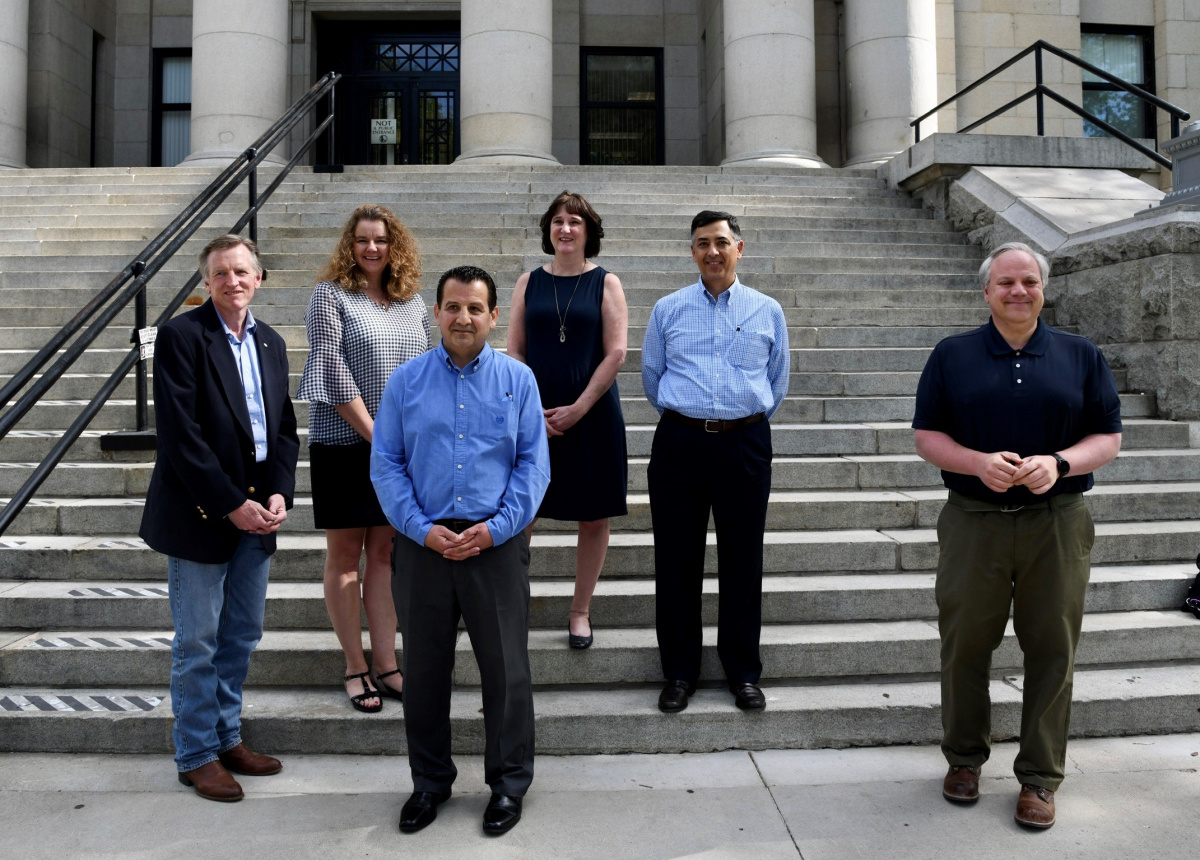 a group of people standing on a courthouse steps