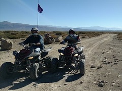 Two ATV riders ride through a valley. Photo by the BLM.