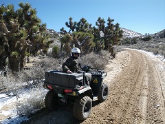 An ATV rider in a snow covered high desert. Photo by the BLM.