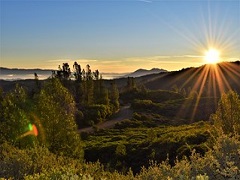 The sun sets over the lush, mountains of the South Cow Mountain OHV Management Area. Photo by Eric Coulter/BLM.