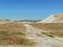 A dusty road through dry hills. Photo by Mike Chiodini/BLM.