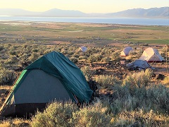 Sunset over tents on Bald Mountain. Photo by Stan Bales, BLM.