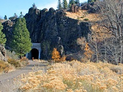 A rail tunnel surrounded by colorful trees. Photo by Jeff Fontana, BLM.